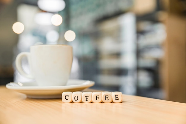 Close-up of wooden coffee cubic blocks with coffee in caf�