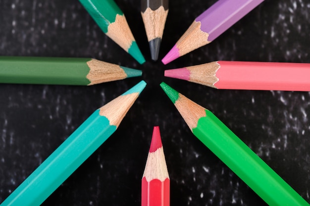 Close-up, wooden crayons arranged in a color wheel.