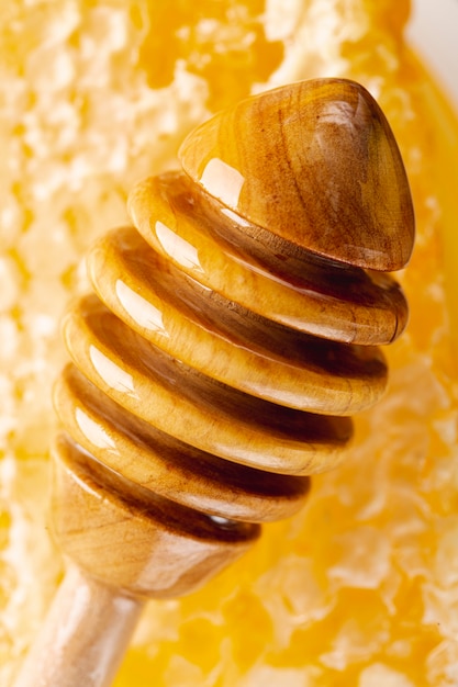 Close up wooden dipper with honeycomb