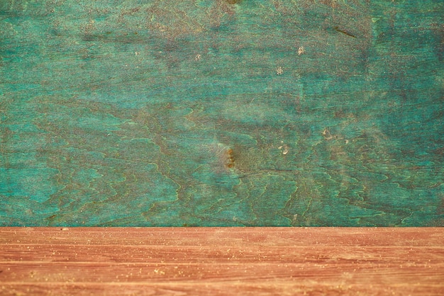 Close-up of wooden floor and green wall