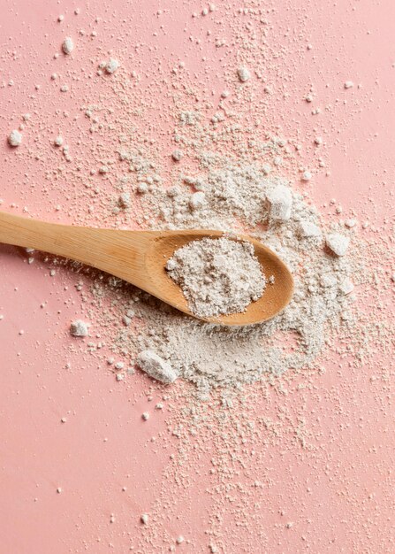 Close up of wooden spoon with clay powder mixture