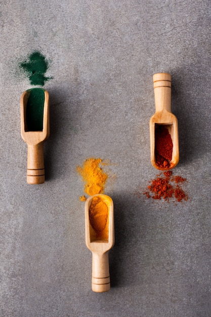Close-up wooden spoons with colorful spices