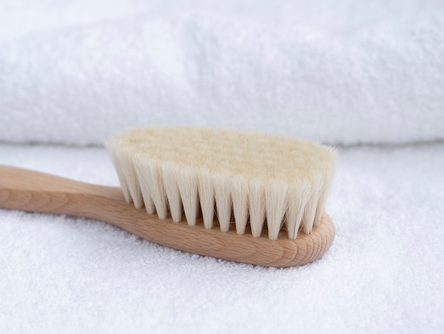Close-up wooden toothbrush with towels