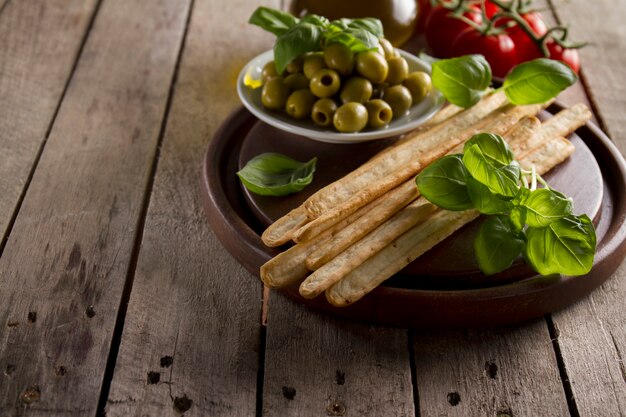 Close-up of wooden tray with tasty aperitives