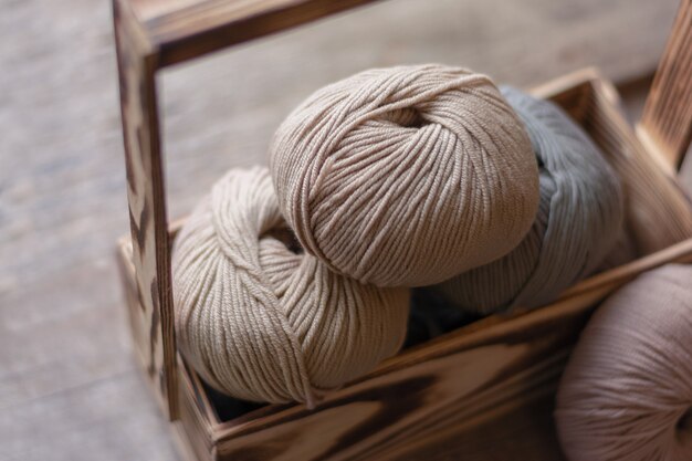 Close up of wool knitting on wooden background