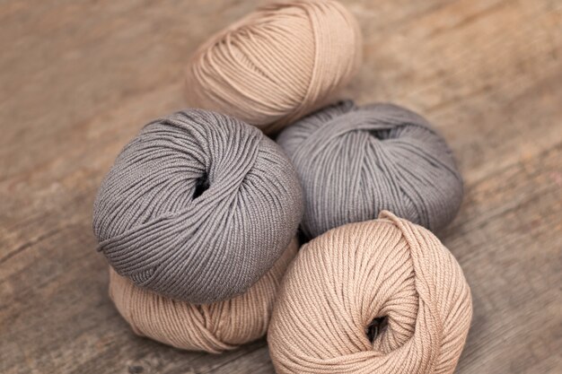 Close up of wool knitting on wooden background