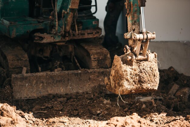 Close up worker backhoe working in construction site