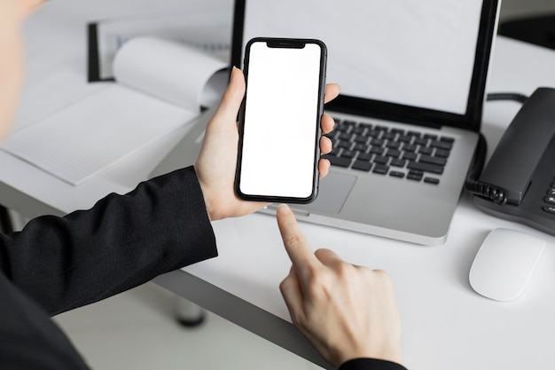 Close-up worker holding mobile phone