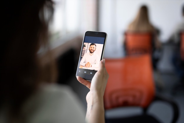 Close up worker holding smartphone