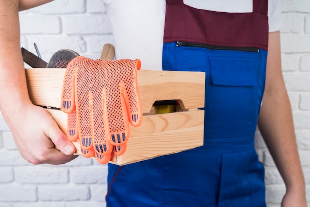 Close-up worker holding a toolbox