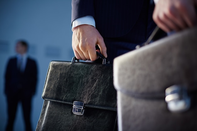 Close-up of workers with briefcases
