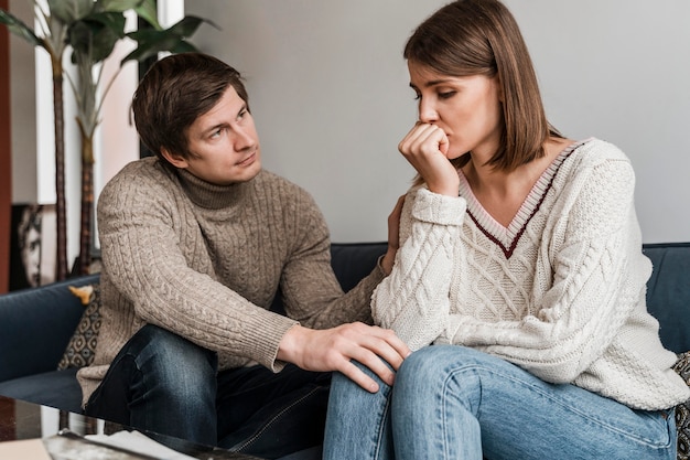 Close-up of a worried woman with her husband