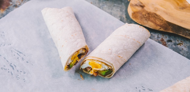 Free photo close-up of wrap tacos with on butter paper