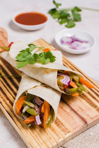 Close-up of wrapped vegetables on chopping board