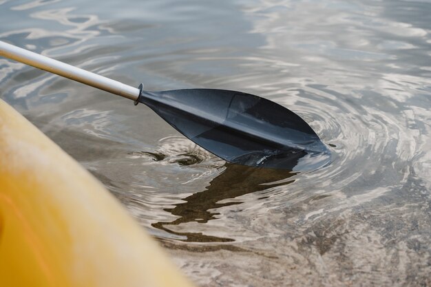 Close up of yellow canoe and row on lake on a sunny day. summer time and sport concept. nobody