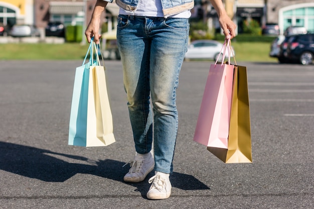 Close up of a young Asian woman shopping an outdoor flea market with a background of pastel buliding