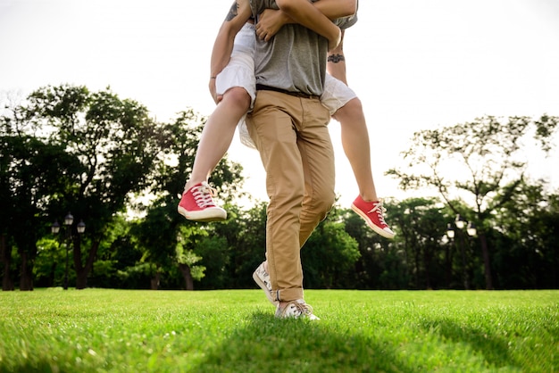 Close up of young beautiful couple rejoicing in park.