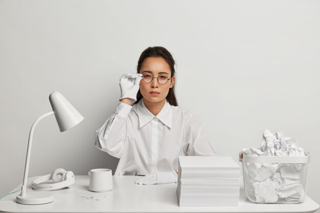 Close up on young beautiful woman at her desk