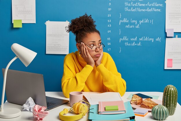 Close up on young beautiful woman at her desk