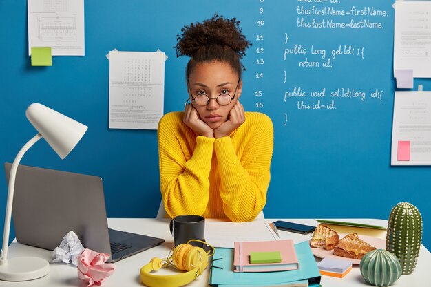 Close up on young beautiful woman at her desk