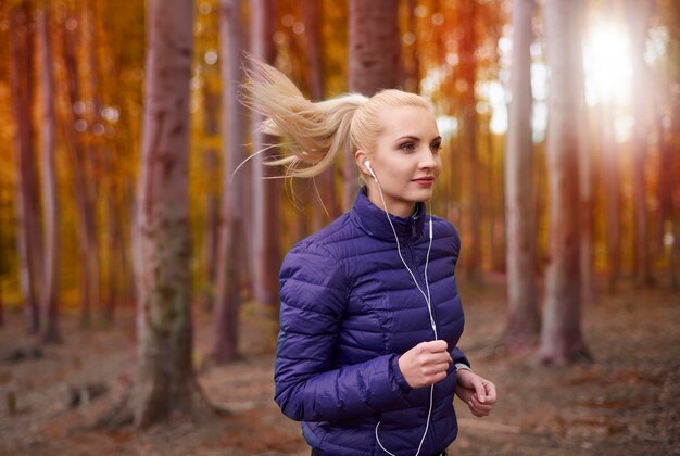 Close up on young beautiful woman jogging