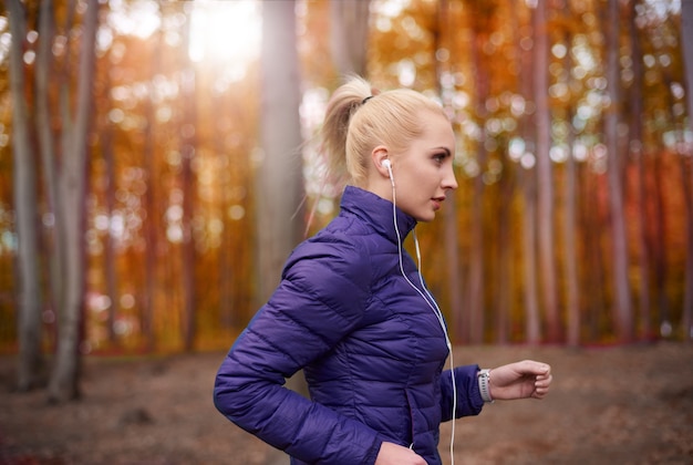 Close up on young beautiful woman jogging