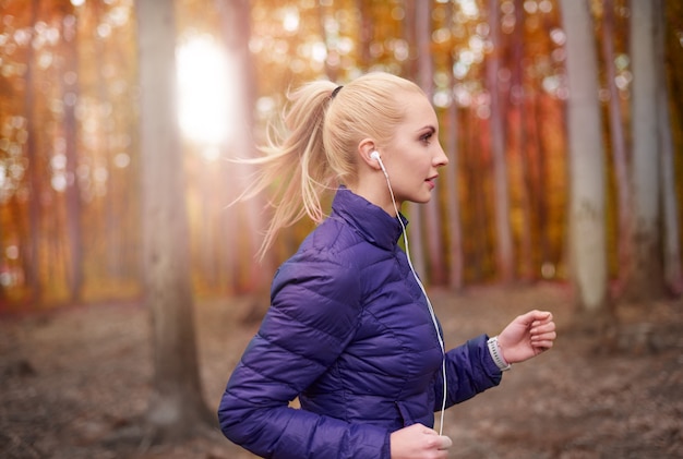 Close up on young beautiful woman jogging