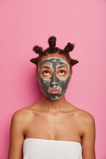 Close up on young beautiful woman with facial mask