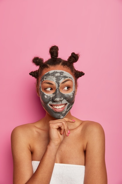 Close up on young beautiful woman with facial mask