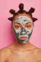 Free photo close up on young beautiful woman with facial mask