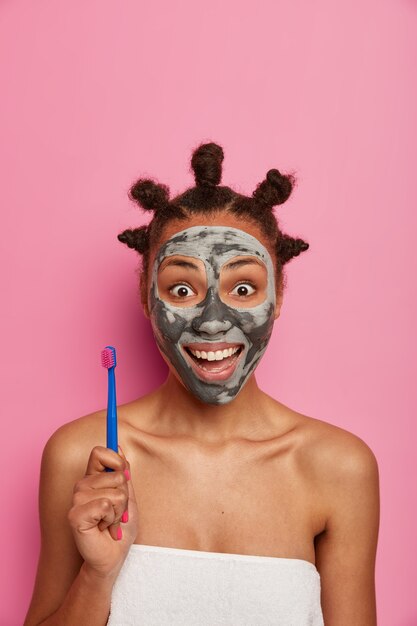 Close up on young beautiful woman with facial mask