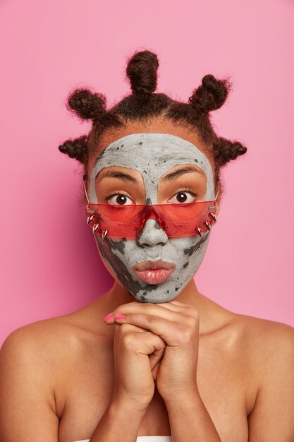 Close up on young beautiful woman with facial mask