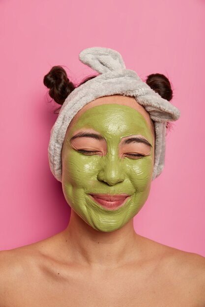 Close up on young beautiful woman with facial mask