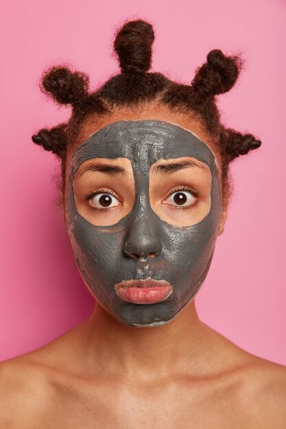 Close up on young beautiful woman with facial mask