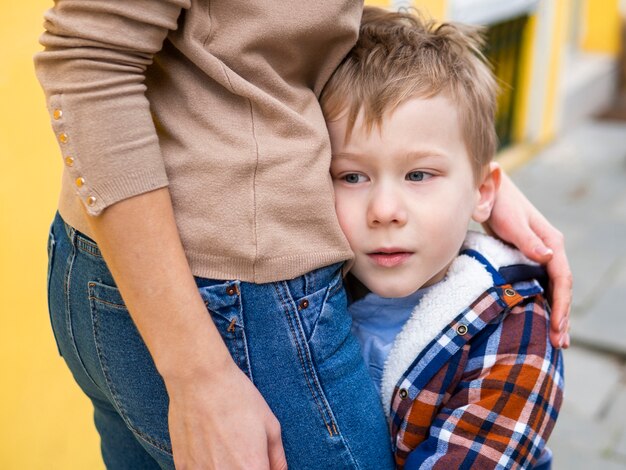 Close-up young boy holding his mother