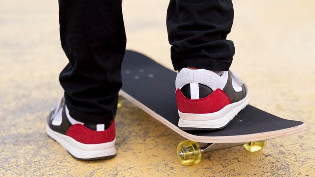 Close-up young boy on skateboard