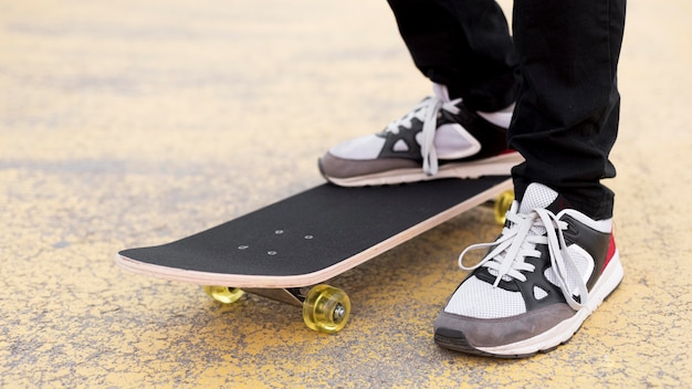 Free photo close-up young boy on skateboard