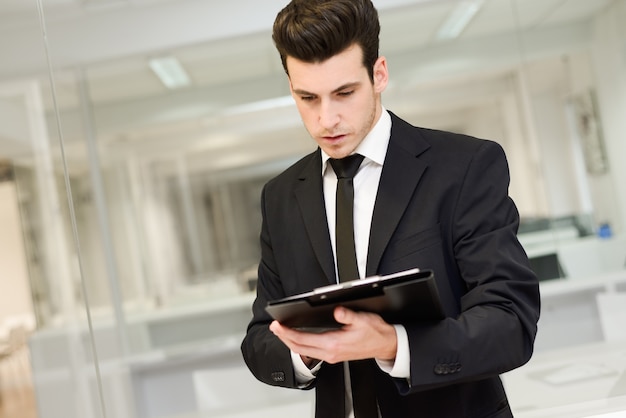 Close-up of young businessman reading a document