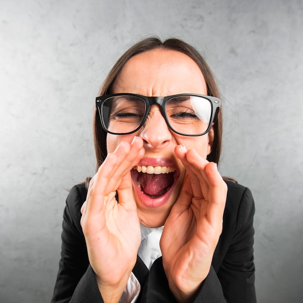 Close-up of a young businesswoman telling a secret