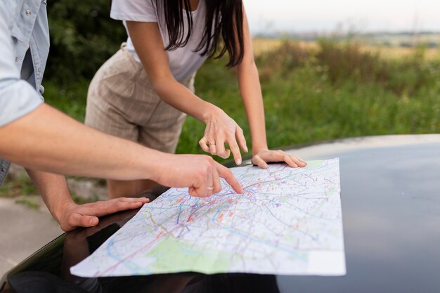 Close-up young couple checking map together