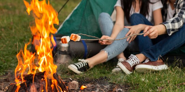 Close-up young couple enjoying bonfire