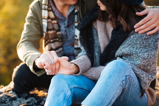 Close-up young couple holding hands