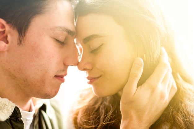 Close-up of young couple standing face to face with closed eyes