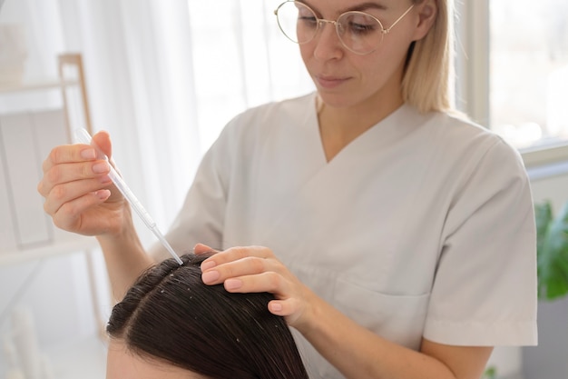 Free photo close up young doctor applying treatment