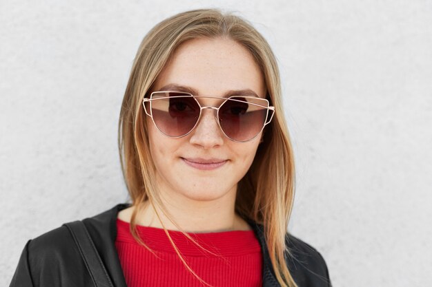 Close up of young female wearing trendy sunglasses