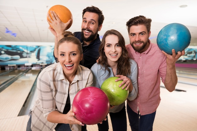 Close up on young friends enjoying bowling