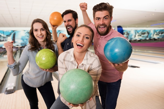 Free photo close up on young friends enjoying bowling