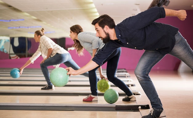 Free photo close up on young friends enjoying bowling