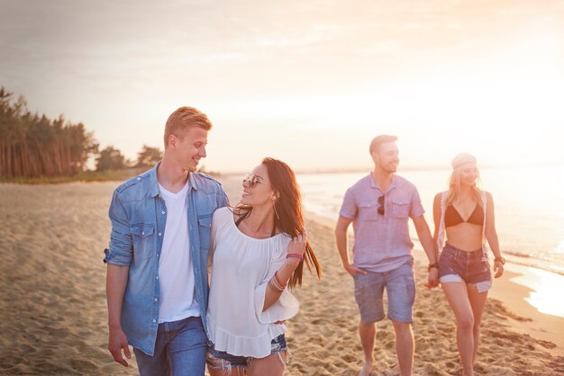 Close up on young friends having fun on the beach