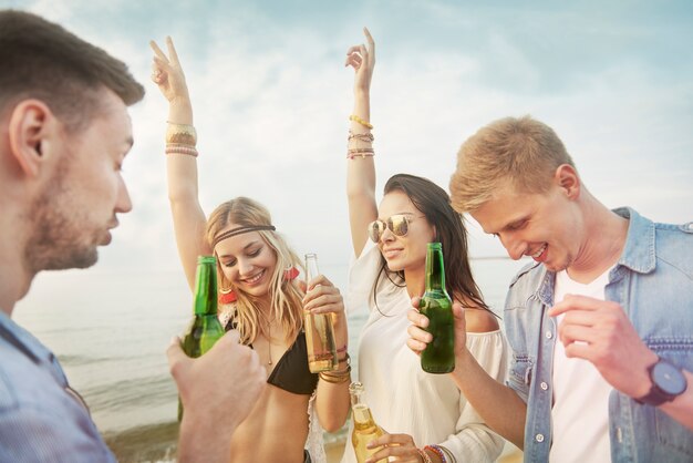 Close up on young friends having fun on the beach